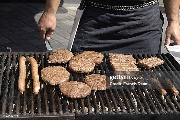 Copenhagen / Denmark. _male grilling burgers and kebabs at Kultuoret 11 July 2013