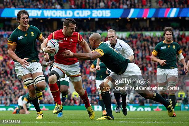 Gareth Davies runs in to score a try for Wales wilth JP Pietersen clinging on to no avail during the IRB RWC 2015 Quarter Final match between Wales v...