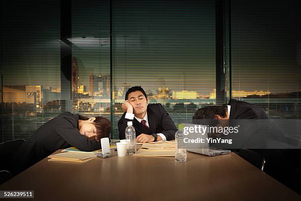 exhausted japanese business office workers in meeting horizontal - overworked stock pictures, royalty-free photos & images