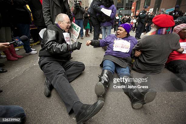 Protestors prepare to be arrested in front of city hall during a Chicago Teachers Union protest in Chicago, March 27, 2013. Chicago will close 54...