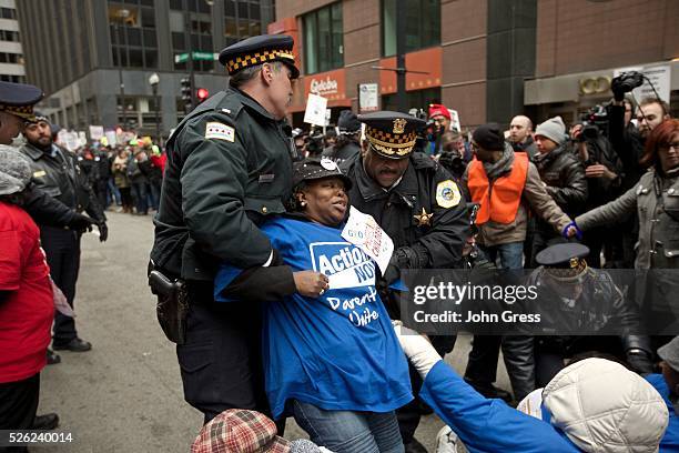 Protester is arrested in front of city hall during a Chicago Teachers Union protest in Chicago, March 27, 2013. Chicago will close 54 schools and 61...