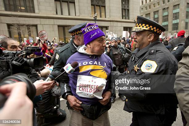 Protester is arrested in front of city hall during a Chicago Teachers Union protest in Chicago, March 27, 2013. Chicago will close 54 schools and 61...