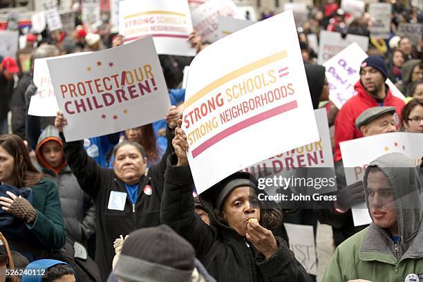 Demonstrators react dying a Chicago Teachers Union protest in Chicago, March 27, 2013. Thousands of demonstrators rallied in downtown Chicago on...