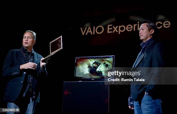 Michael Abary, right, Senior Vice President of marketing for Sony, looks on as Dave Fester, left, General Manager of Microsoft Corp.'s Windows...