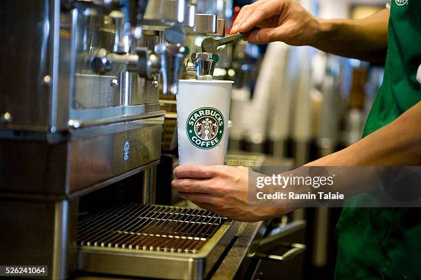 Starbucks barista prepares a drink at a Starbucks Coffee Shop location in New York, Wednesday, January 13, 2010.