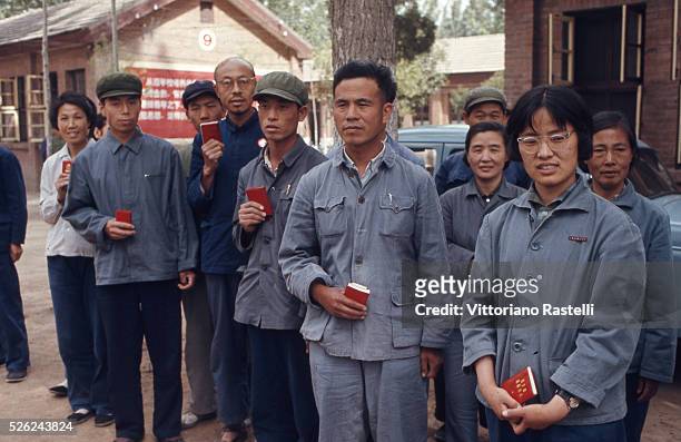 Beijing, China - Factory workers hold Mao Zedong,s Red Book in Beijing, May 21 1971