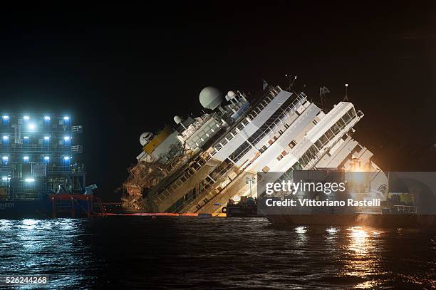 Giglio Island, Italy - The Costa Concordia cruise liner is shown 14 hours after the start of the operation to have it turned upright at Giglio...