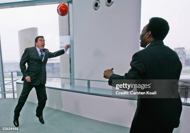 German Chancellor Gerhard Schroeder plays soccer with Brazilian soccer star Pele following talks in Schroeder's Chancellery April 13, 2005 in Berlin,...