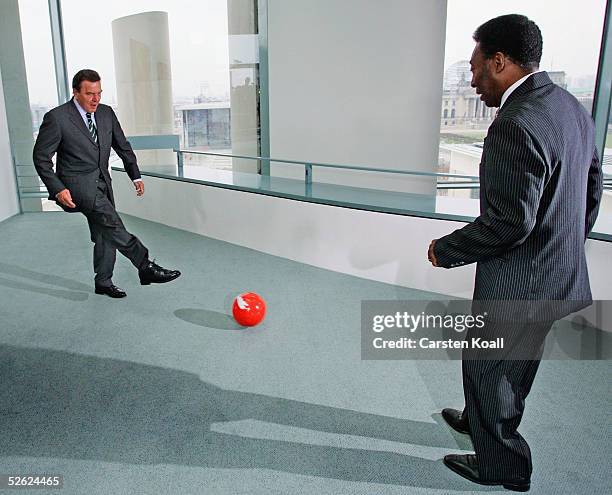 German Chancellor Gerhard Schroeder plays soccer with Brazilian soccer star Pele following talks in Schroeder's Chancellery on April 13, 2005 in...