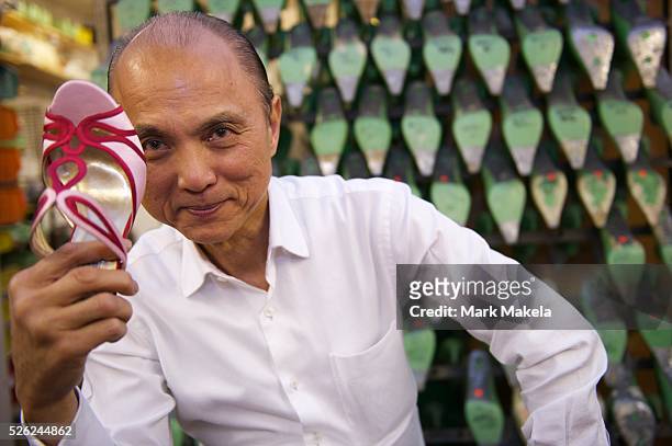 Fashion designer Jimmy Choo in his studio on Cannaught Street with a pair of bespoke shoes.