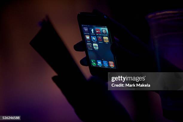 Member of the crowd illuminates the music program with with an iphone at the 10th annual Summer Sundae festival in Leicester on August 15, 2010.