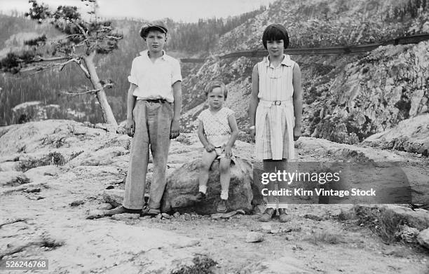Three siblings pose at Donner Pass on vacation, ca. 1938