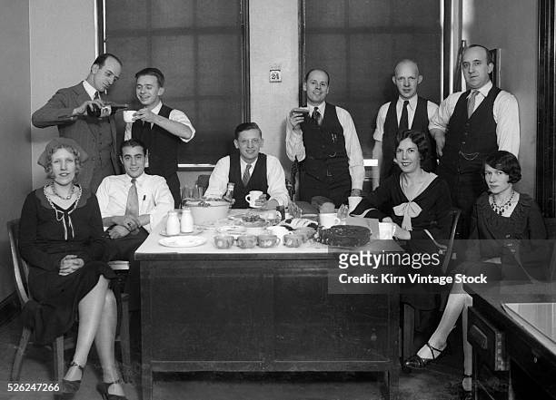 Office Christmas party around the boss's desk in 1930