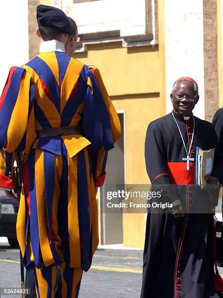 Cardinal Francis Arinze of Nigeria Prefect Emeritus of Divine Worship and the Discipline of the Sacraments leaves the meeting to prepare the next...