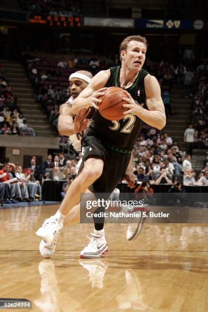 Fred Hoiberg of the Minnesota Timberwolves drives around Vince Carter of the New Jersey Nets during the game at Continental Airlines Arena on March...