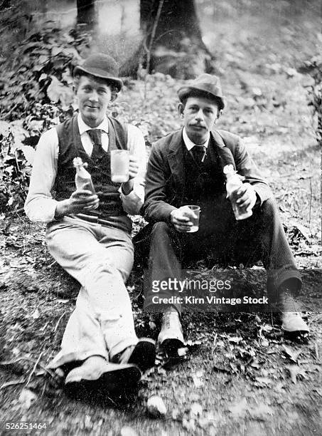 Young men drink in the woods, ca. 1885.