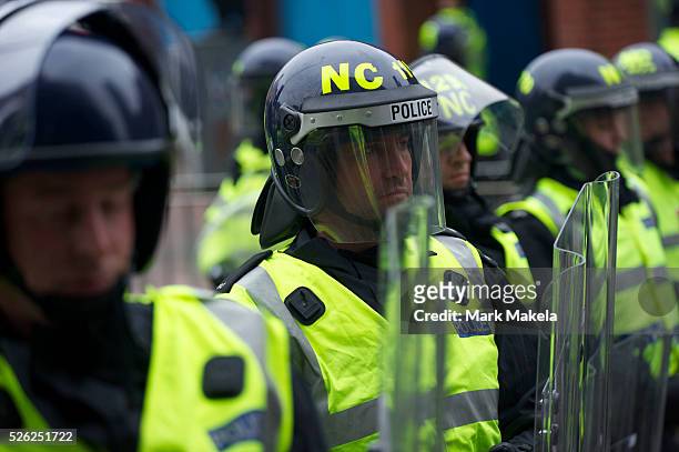 Phalanx of police officers, numbering in excess of 1 equipped with riot gear and security dogs, kept a rally of 1,000 English Defence League members...