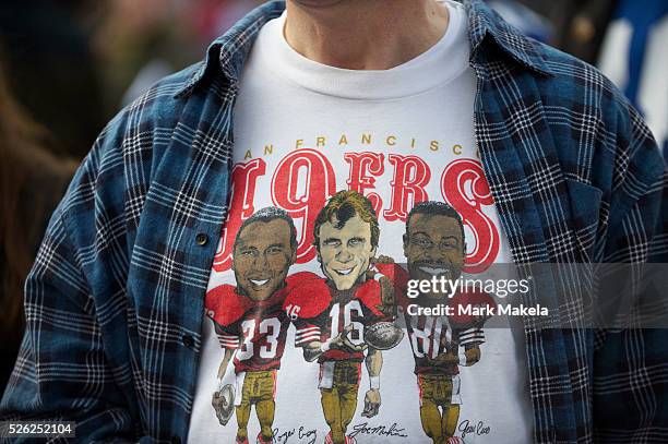 San Francisco 49er fan wears a vintage t-shirt featuring all time great players, Roger Craig, Joe Montana, and Jerry Rice during the NFL rally at...