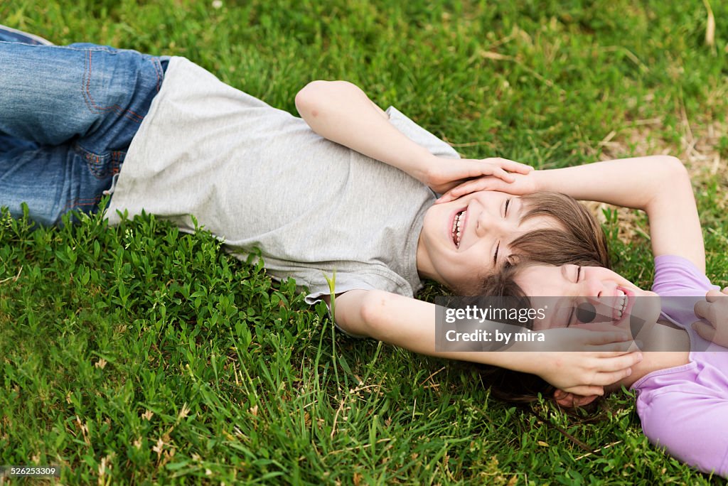 Boy and girl hugging on the grass