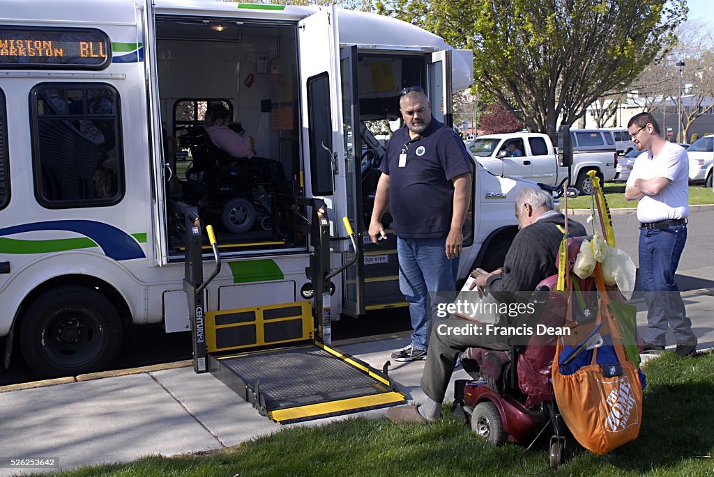 Bus dirver helping handicape usa senior citizen to left him in Lewiston Blue line bus .