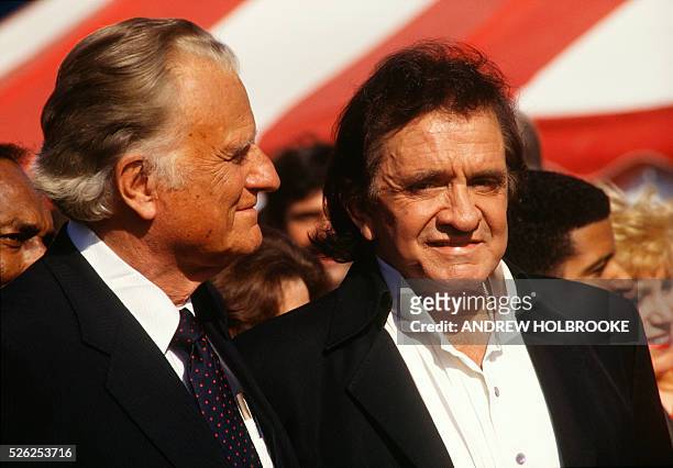 Johnny Cash with Billy Graham in New York's Central Park where Billy Graham spoke to a crowd estimated at 250,000 people, the largest crowd ever to...