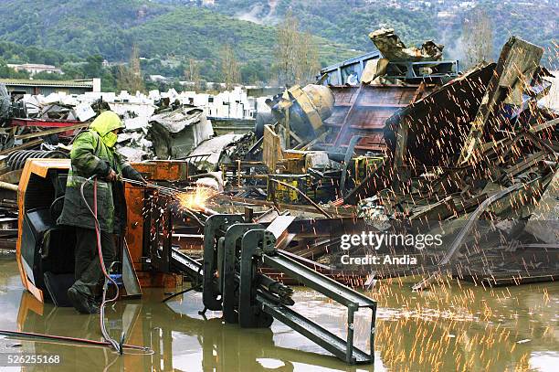 The company "Derichebourg environnement Recyclage" manages waste treatment. Recycling of steel, plastic and rubber. Worker using a blowtorch to...