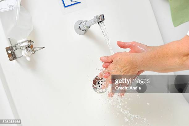 Medical staff cleaning their hands with a hand sanitizer ( to prevent hospital-acquired infections.