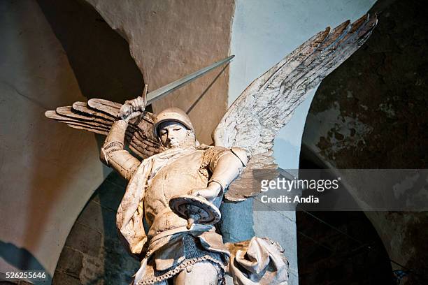 Statue, in the abbey of Mont Saint-Michel , of the archangel Saint Michael bringing down the dragon.
