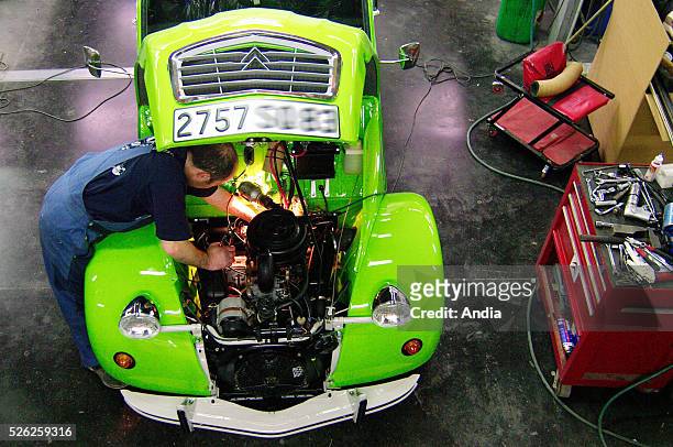 Workshop of the Citroen 2CV Mehari Club in Cassis, where 2CV cars are repaired, and which production has ceased in Portugal in 1990. Mechanic working...