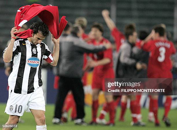 Juventus captain Alex Del Piero walks away from the pitch as Liverpool player jubilate at the end of Champion's League quarter final second leg...