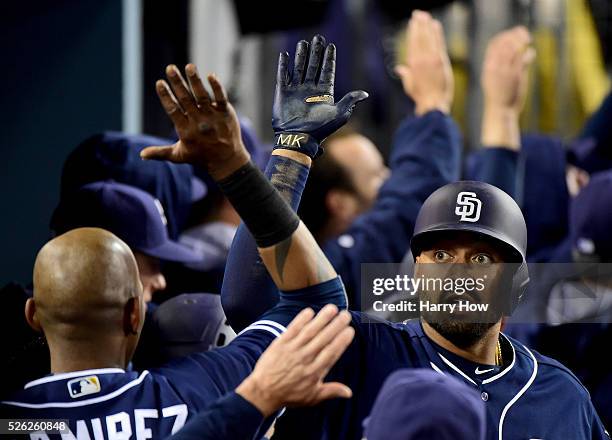 Matt Kemp of the San Diego Padres celebrates his three run homerun with Alexei Ramirez to take a 4-1 lead over the Los Angeles Dodgers during the...