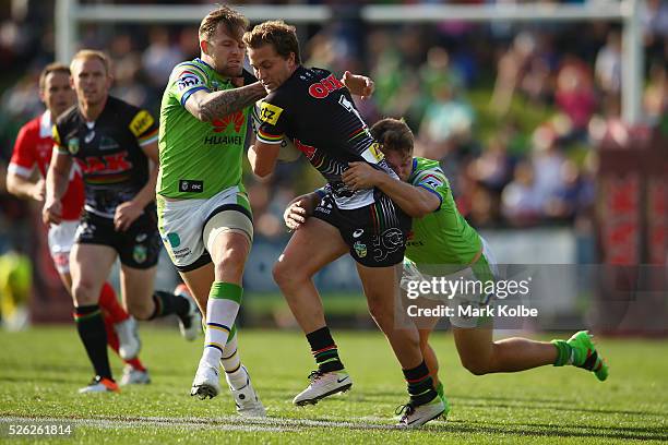 Matt Moylan of the Panthers is tackled during the round nine NRL match between the Penrith Panthers and the Canberra Raiders at Carrington Park on...