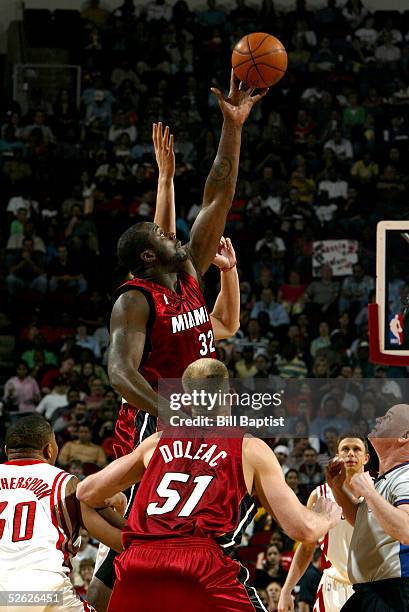 Shaquille O'Neal of the Miami Heat tips a jump ball during the game with the Houston Rockets on March 22, 2005 at the Toyota Center in Houston,...