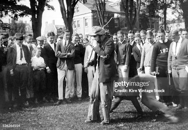 Crowd of students gather to watch what appears to be a hazing prank on the campus of Dartmouth College in the 1920s.