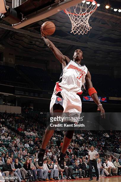 Gerald Wallace of the Charlotte Bobcats dunks against the Atlanta Hawks in the first quarter on April 13, 2005 at the Charlotte Coliseum in...