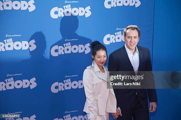 Alice Kim and Nicolas Cage attend The Croods film premiere at the AMC Loews Lincoln Square in New York City. �� LAN