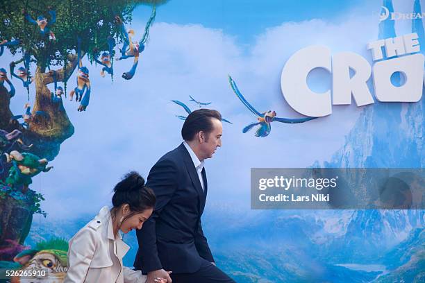 Alice Kim and Nicolas Cage attend The Croods film premiere at the AMC Loews Lincoln Square in New York City. �� LAN