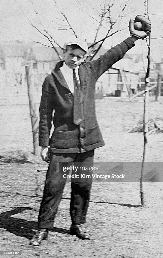 Teenage boy plays catch, ca. 1912