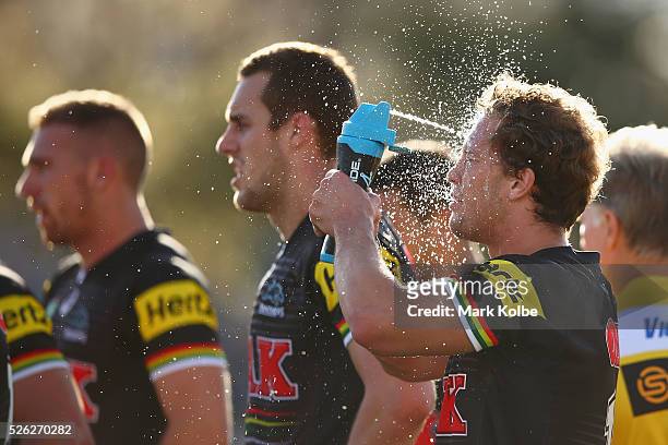 Matt Moylan of the Panthers sprays water on his face to cool down during the round nine NRL match between the Penrith Panthers and the Canberra...