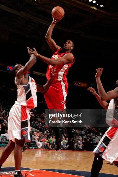 Donta Smith of the Atlanta Hawks goes up for a shot against Emeka Okafor of the Charlotte Bobcats April 13, 2005 at the Charlotte Coliseum in...