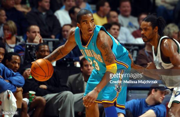 Smith of the New Orleans Hornets backs the ball in against Latrell Sprewell of the Minnesota Timberwolves on March 23, 2005 at the Target Center in...