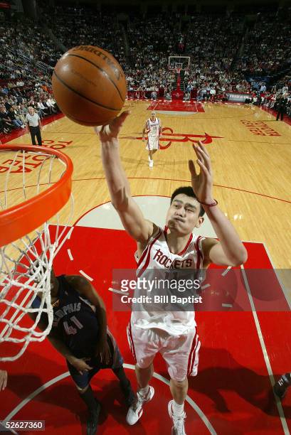 Yao Ming of the Houston Rockets shoots in front of James Posey of the Memphis Grizzlies on April 13, 2005 at the Toyota Center in Houston, Texas....