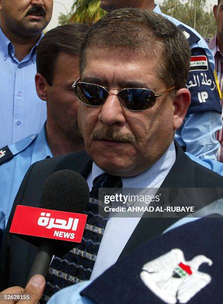 Outgoing Iraqi interior minister Falah Naqib speaks to reporters as he arrives at the scene of a double suicide bombing in Baghdad 14 April 2005. At...