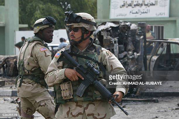 Soldiers secure the scene of a double suicide bombing in Baghdad 14 April 2005. At least 11 people were killed and 28 wounded in the twin attack was...