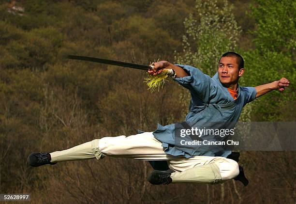 Warrior monk of the Shaolin Temple displays his Kung Fu skills at the Songshan Mountain near the temple April 12, 2005 in Dengfeng, Henan Province,...