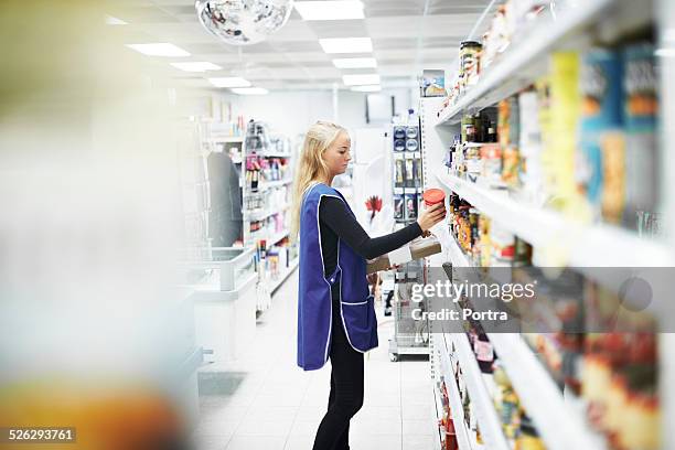 female worker working at convenience store - tante emma laden stock-fotos und bilder