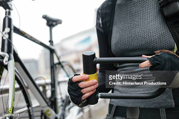 woman with bicycle lock - bicycle lock stock pictures, royalty-free photos & images