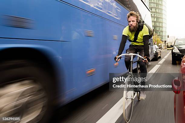 bike messenger on bicycle - bus road stock pictures, royalty-free photos & images