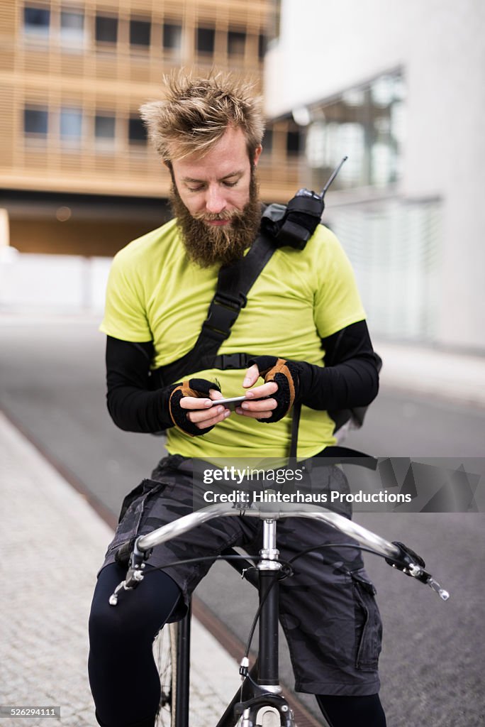 Bike Messenger Texting On Smart Phone