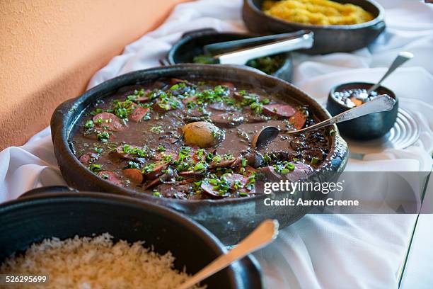 bowls of traditional beans and rice on buffet table - feijoada stockfoto's en -beelden